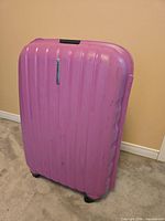 Front view of pink suitcase showing hard shell and ribbing