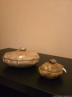 Large and small potato-shaped covered bowls closed