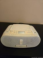 Front view of Sony boombox showing speakers, dock door, controls