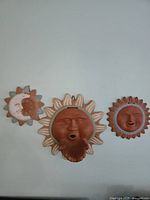 Front view of all three terracotta plaques on wall