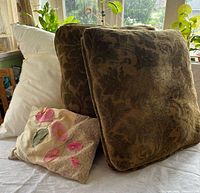 All four cushions grouped: two green velvet, one white form, one appliqué