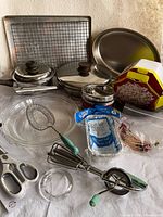 Full grouping of cookware, bakeware, whisks, scissors, tiffin, popcorn popper, loaf pans and picks