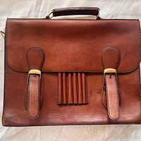 Front view showing buckles, pen slots, handle