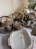 Overall view of stainless saucepans, stock pot with insert, and CorningWare casserole