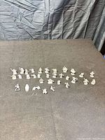 overview of all 32 miniatures spread on tabletop