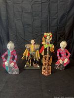 Group shot showing all five dolls and figurine for scale and completeness