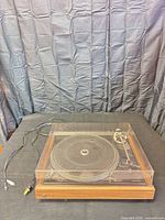 Top view of Dual 506 turntable with dust cover and cables visible