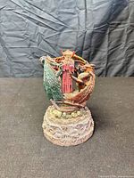 Front view of wizard and dragon figurine on base