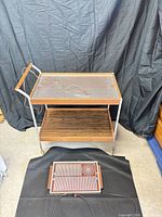 Full view of chrome serving cart with integrated warming tray and separate small warming tray