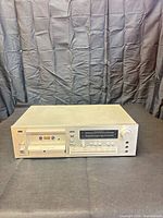 Front view showing silver brushed-metal Sansui D-350M cassette deck with cassette well, controls, and LED level meter