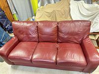 Front view of red burgundy leather three-seat sofa