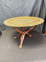 Full view of brass tray side table on wooden base