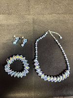 Full view of necklace, bracelet and earrings showing stone colour and design