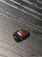 Top view of the black opal showing multicolor play-of-color