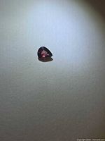 Pear-shaped hot pink zircon viewed from top