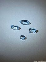 Four loose aquamarines on white background