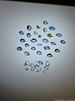 Group view of all loose multicolour tanzanite stones on white background