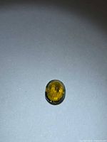Front view of oval golden tourmaline on neutral background