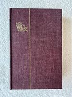 Front cover showing maroon cloth, gilt ship and vertical line
