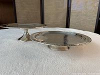 Two silver plated pedestal cake stands, side view