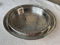 Both trays stacked showing size difference and decorative rims