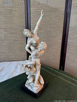 Front view of A. Santini two-figure sculpture on base