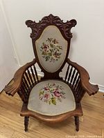Front view showing carved frame, needlepoint back and seat