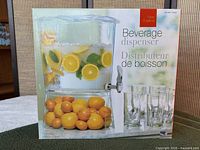 Front of boxed acrylic beverage dispenser