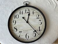 Front view of round clock showing numerals and hands