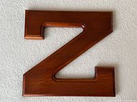 Front view of solid wood letter Z showing routed edges and finish
