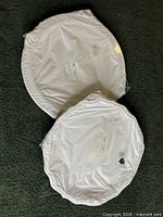Two shrinkwrapped platters overlapping showing full size and labels