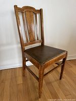 Front view of wooden chair showing seat and backrest