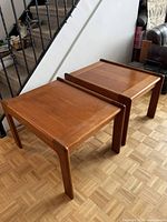Both teak side tables front three-quarter view