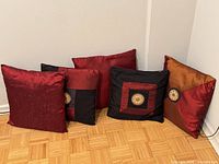 Five pillows grouped against wall