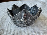 Bracelet closed showing exterior deity panels and tapered shape