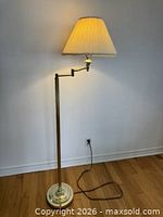 Full view of lamp standing with shade and cord visible