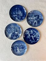 Front view showing all five blue and white limited edition wall plates