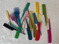assorted coloured combs spread out on surface
