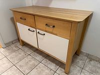 Front left view showing drawers, doors, handles, legs