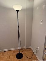 Full view of lamp showing pole, shade, base and cord