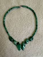 Full view of jade bead necklace laid flat showing entire design