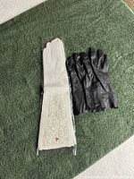 White long gloves and black gloves side by side