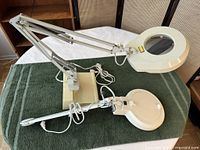 Two magnifying lamps on towel showing overall form