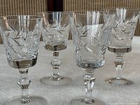 Five of the crystal stem glasses showing pinwheel cuts and faceted stems