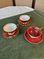 Three teacup and saucer sets displayed top view