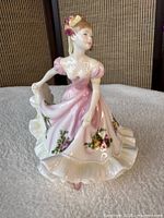 Front view of the Royal Doulton Flowers of Love figurine showing dress details
