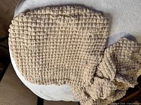 Top view of one beige waffle-texture seat cover