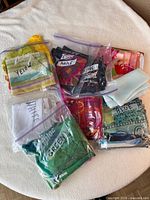 Ziploc bags labelled Yellow, Purple, Green, Blue, White containing folded scarves