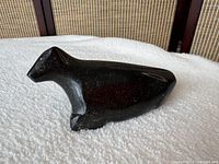 left profile of dark green-black soapstone animal carving