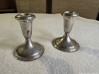 Pair of candlesticks top and side view showing form and tarnish